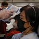 Close range: Flight attendants wielding the temperature gun aboard a flight from Melbourne to Beijing.